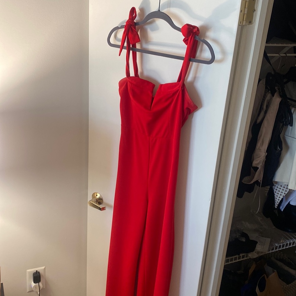 Floor length red jumpsuit. Super flattering. Tie straps on shoulders